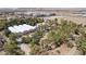 Aerial view of lot containing several greenhouse structures amid the vast desert and suburban landscape at 55 Siddall Ave, Las Vegas, NV 89183