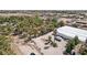 Aerial view of expansive lot featuring several structures and mature trees amid desert landscape at 55 Siddall Ave, Las Vegas, NV 89183