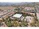 Aerial view of lot containing several greenhouse structures amid the vast desert and suburban landscape at 55 Siddall Ave, Las Vegas, NV 89183