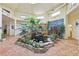 Beautiful atrium featuring a tranquil indoor garden, natural light, and unique architectural design at 55 Siddall Ave, Las Vegas, NV 89183