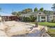 Large backyard with a covered swimming pool, patio, and lush landscaping in a well-maintained yard at 55 Siddall Ave, Las Vegas, NV 89183