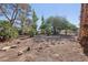 Lush backyard with mature trees creating a serene outdoor space at 55 Siddall Ave, Las Vegas, NV 89183