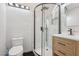 Modern bathroom featuring a glass-enclosed shower with matte black hardware and a wooden vanity at 55 Siddall Ave, Las Vegas, NV 89183