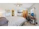 Bright bedroom featuring a ceiling fan, a large bed, closet space, and a designated workstation at 55 Siddall Ave, Las Vegas, NV 89183