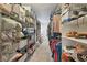 A walk in closet features wire and white shelving full of assorted clothing and storage at 55 Siddall Ave, Las Vegas, NV 89183