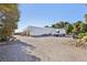 Outdoor shot of the property with a greenhouse and commercial van on a gravel lot at 55 Siddall Ave, Las Vegas, NV 89183