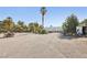 Exterior shot of the property with a greenhouse and commercial van on a gravel lot at 55 Siddall Ave, Las Vegas, NV 89183