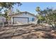 Detached garage featuring a roll up door and a fenced yard at 55 Siddall Ave, Las Vegas, NV 89183