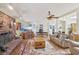 Cozy living room with brick fireplace, wood-paneled ceiling, and ample natural light at 55 Siddall Ave, Las Vegas, NV 89183
