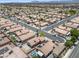 Wide aerial view showcasing a neighborhood with homes, pools, and desert landscaping at 5550 Ramirez St, North Las Vegas, NV 89031