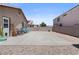 Spacious backyard featuring a concrete patio with desert rock landscaping and privacy wall at 5550 Ramirez St, North Las Vegas, NV 89031