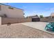 View of large concrete patio with desert rock and storage shed at 5550 Ramirez St, North Las Vegas, NV 89031