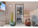 Backyard patio is the entry point to a home with chairs, shrubbery, and beautiful surroundings at 5550 Ramirez St, North Las Vegas, NV 89031
