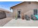 Backyard patio is the entry point to a home with chairs, shrubbery, and beautiful surroundings at 5550 Ramirez St, North Las Vegas, NV 89031