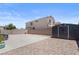 Wide angle of gravel backyard with concrete patio and storage shed at 5550 Ramirez St, North Las Vegas, NV 89031