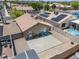 Aerial view of a backyard with a patio, desert landscaping, and a partial view of a pool at 5550 Ramirez St, North Las Vegas, NV 89031