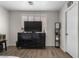 This bedroom features a ceiling fan, a large dresser, and hardwood flooring at 5550 Ramirez St, North Las Vegas, NV 89031