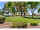 A well-maintained community park with lush green grass, mature trees, and playground equipment at 5550 Ramirez St, North Las Vegas, NV 89031