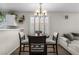 Cozy dining area with stylish chairs, modern lighting, and a view into the comfortable living space at 5550 Ramirez St, North Las Vegas, NV 89031