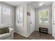 Bright entryway with tile flooring, white walls, and natural light streaming through the windows with shutters at 5550 Ramirez St, North Las Vegas, NV 89031