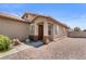 Inviting entrance with desert landscaping, plants, and a covered porch, creating a warm and welcoming ambiance at 5550 Ramirez St, North Las Vegas, NV 89031