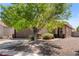 Charming single-story home featuring mature shade tree, two-car garage, and low maintenance desert landscaping at 5550 Ramirez St, North Las Vegas, NV 89031