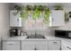 Updated kitchen features white cabinets, a stainless sink, and modern appliances at 5550 Ramirez St, North Las Vegas, NV 89031