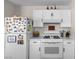 Well-equipped kitchen featuring white appliances and great lighting at 5550 Ramirez St, North Las Vegas, NV 89031