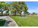 Community park featuring mature trees, walking path, picnic benches, playground and well-maintained green spaces at 5550 Ramirez St, North Las Vegas, NV 89031