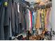 A walk-in closet is filled with shelves, racks, clothes, and storage space at 5550 Ramirez St, North Las Vegas, NV 89031