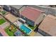 Aerial view showcases the home's backyard, including a pool, play structure and landscape design at 5788 Robin Ridge Ave, Las Vegas, NV 89141