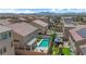 The aerial perspective highlights backyards with pools and recreational spaces, showcasing the neighborhood's appeal at 5788 Robin Ridge Ave, Las Vegas, NV 89141