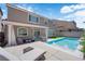 Stunning backyard features a sparkling pool, covered patio, and lounge chair for relaxation at 5788 Robin Ridge Ave, Las Vegas, NV 89141