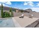 Secluded backyard escape featuring a refreshing pool, lounge chair, and stylish egg chair at 5788 Robin Ridge Ave, Las Vegas, NV 89141