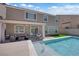 Inviting backyard oasis featuring a refreshing pool, covered patio, and comfortable seating area at 5788 Robin Ridge Ave, Las Vegas, NV 89141