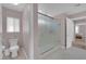 Modern bathroom featuring a frosted glass shower, toilet, and grey tile flooring at 5788 Robin Ridge Ave, Las Vegas, NV 89141
