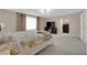 Bright bedroom featuring neutral walls, soft carpet, and a large window with curtains at 5788 Robin Ridge Ave, Las Vegas, NV 89141