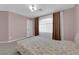 Bright bedroom featuring neutral walls, soft carpet, and a large window with curtains at 5788 Robin Ridge Ave, Las Vegas, NV 89141