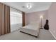 Bedroom featuring a stylish bed, lamp, and a guitar beneath a modern ceiling light at 5788 Robin Ridge Ave, Las Vegas, NV 89141