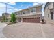 A wide, brick driveway leads to a 3-car garage in front of this two-story home at 5788 Robin Ridge Ave, Las Vegas, NV 89141