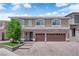 Stately two-story home featuring a manicured front lawn and a three-car garage at 5788 Robin Ridge Ave, Las Vegas, NV 89141