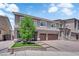 Two-story home with a three-car garage, stone accents, and a landscaped front yard at 5788 Robin Ridge Ave, Las Vegas, NV 89141