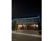 Gorgeous home featuring a three-car garage, a brick driveway, and vibrant blue lighting on the roof line at nighttime at 5788 Robin Ridge Ave, Las Vegas, NV 89141