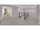 Upstairs hallway offers a view of rooms with neutral paint, carpet, and modern railings at 5788 Robin Ridge Ave, Las Vegas, NV 89141