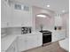 Well-appointed kitchen with stainless steel appliances, white countertops, and ample cabinet space at 5788 Robin Ridge Ave, Las Vegas, NV 89141