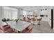 Bright kitchen with white cabinets, stainless steel appliances and an island with counter seating at 5788 Robin Ridge Ave, Las Vegas, NV 89141