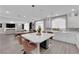 Bright open kitchen with a large island, stainless steel appliances, and sleek white cabinets at 5788 Robin Ridge Ave, Las Vegas, NV 89141