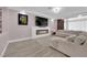 Cozy living room with a fireplace, large television, and comfortable seating at 5788 Robin Ridge Ave, Las Vegas, NV 89141