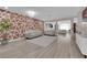 Spacious living room with modern decor, an accent wall, and an open floor plan at 5788 Robin Ridge Ave, Las Vegas, NV 89141