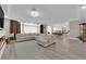 Open-concept living room with modern lighting, dining area, and view of kitchen at 5788 Robin Ridge Ave, Las Vegas, NV 89141